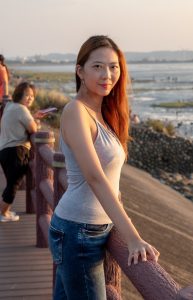 夕阳下穿吊带背心牛仔裤的韵味少妇