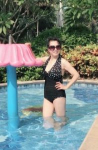 大姐穿泳装在泳池拍照